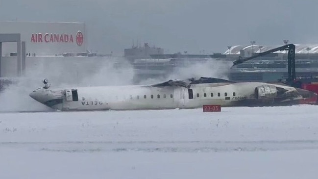 The smoking aircraft on the runway after flipping.