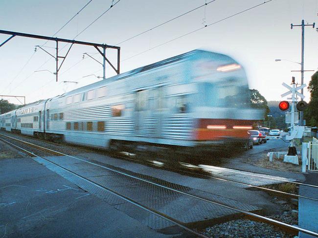 Train passes through Woy Woy level crossing Picture: Mark Scott