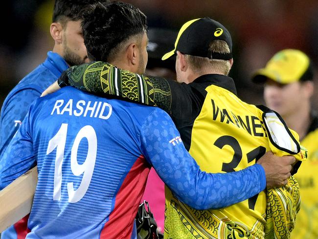 David Warner embraces Afghanistan's Rashid Khan at the World Cup in 2022 Picture: Brenton EDWARDS / AFP