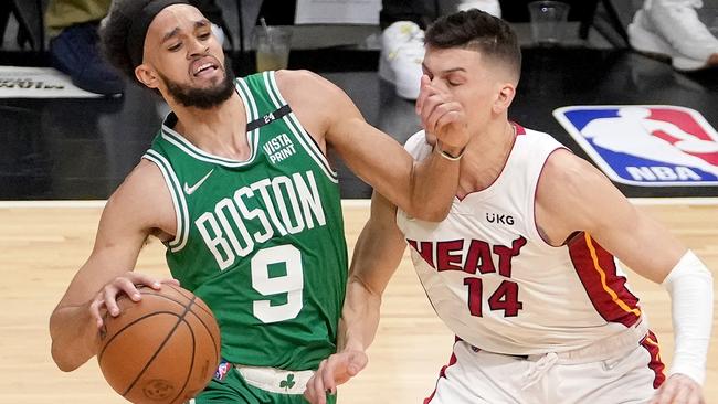 MIAMI, FLORIDA - MAY 29: Derrick White #9 of the Boston Celtics drives the ball against Tyler Herro #14 of the Miami Heat during the first quarter in Game Seven of the 2022 NBA Playoffs Eastern Conference Finals at FTX Arena on May 29, 2022 in Miami, Florida. NOTE TO USER: User expressly acknowledges and agrees that, by downloading and/or using this photograph, User is consenting to the terms and conditions of the Getty Images License Agreement. (Photo by Eric Espada/Getty Images)