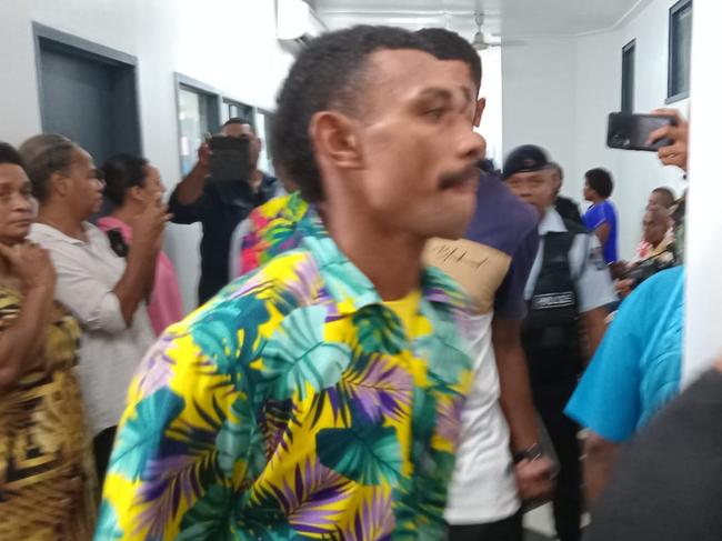 Ilaisa Tanoa, 24, is escorted from a police vehicle to a holding cell at Nadi Magistrate's Court on Monday. ( in the colored shirt )Ilaisa allegedly pretended to be a taxi driver and raped a Virgin Australia crew member faces court for the first time. The man appeared in Nadi Magistrates Court on the island’s west coast on Monday morning, charged with one count of rape and one count of sexual assault for an attack on the 21-year-old flight attendant who was celebrating New Year’s Eve on a layover.