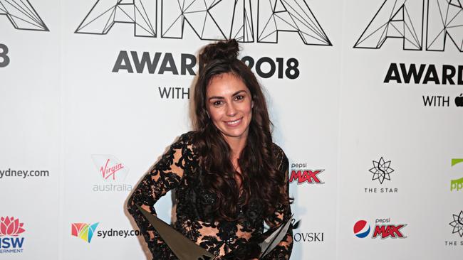 Amy Shark won Best Female Artist, Apple Music Album of the Year, Best Pop Release and Producer of the Year during the 32nd ARIA Awards at The Star in Sydney last year. Now she is touring the UK but has revealed a dramatic incident when stowaways were discovered in her tour bus luggage compartment. (AAP Image/Adam Yip)