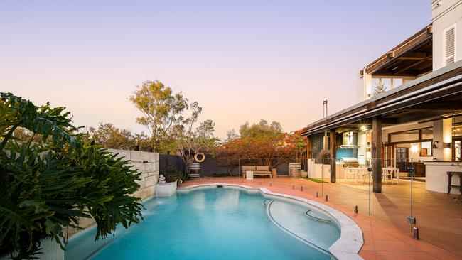 The glass-framed in-ground swimming pool with a water feature at 38 Portside Place, Bulimba is set to be a hit with buyers