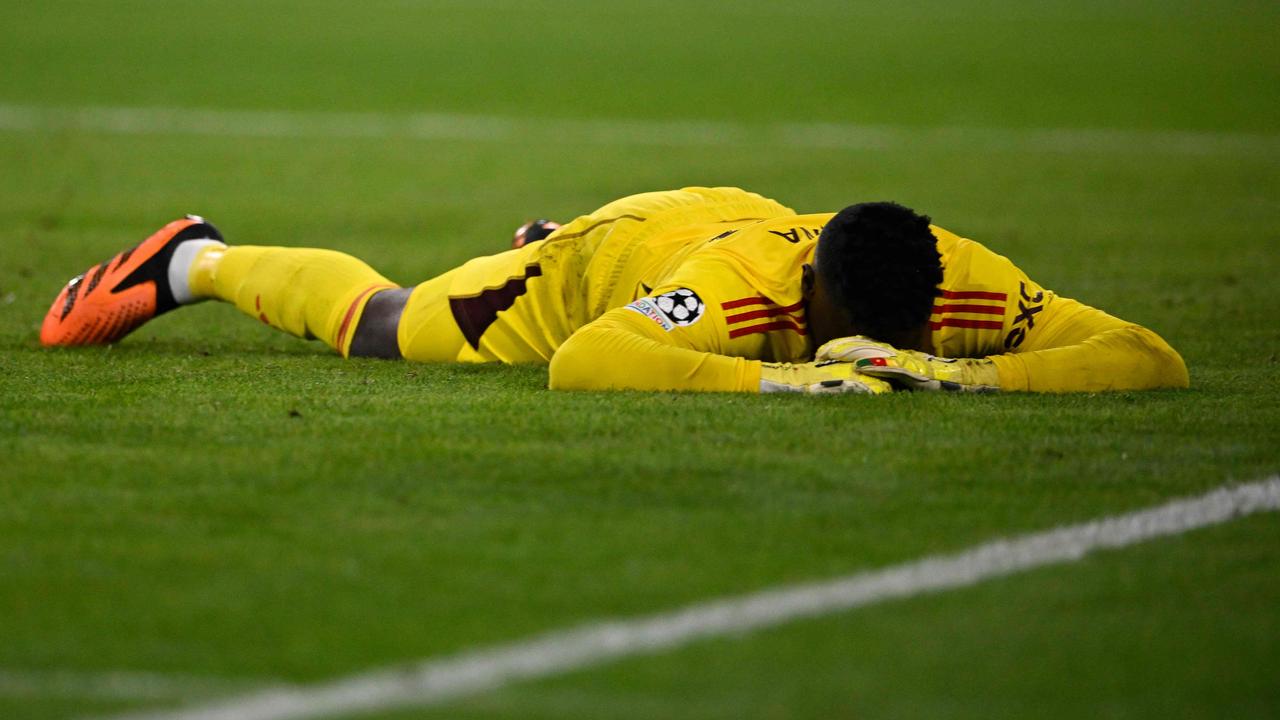 Andre Onana wanted the ground to swallow him whole after a goalkeeping howler. (Photo by Tobias SCHWARZ / AFP)