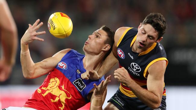 Lions forward Eric Hipwood (left) battles Adelaide’s Chayce Jones in Brisbane’s 36-point weekend win. Picture: Sarah Reed/AFL Photos via Getty Images