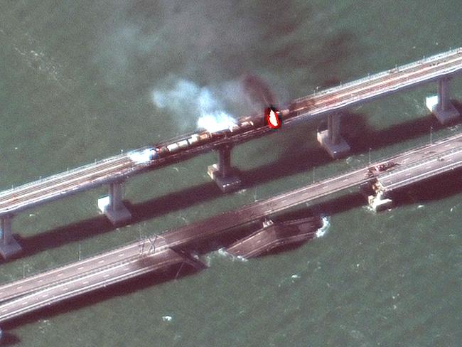 This satellite image taken and released by Maxar Technologies shows smoke billowing from a fire on the Crimea Bridge after a truck exploded. Picture: Handout / Satellite image Â©2019 Maxar Technologies / AFP