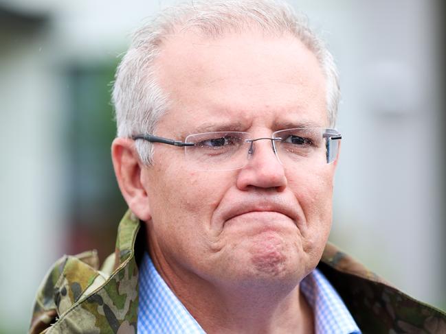 Prime Minister Scott Morrison is seen visiting flood affected areas in Townsville, Tuesday, February 5, 2019. Hundreds of people still waiting for help and evacuation centres are filling up fast, with unprecedented water releases from the city's swollen dam having sent torrents of water down the Ross River and into the city, swamping roads, yards and homes. (AAP Image/Dave Acree) NO ARCHIVING