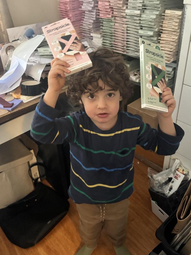 Now three years old, Archie, enjoys helping his mum pack orders. Picture: Supplied.