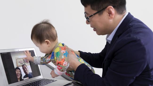 Zhanwei Hou and his son Baoxi Hou. Dr Hou is working on technology that will enable video calls to be tactile. Picture: Louise Cooper/University of Sydney