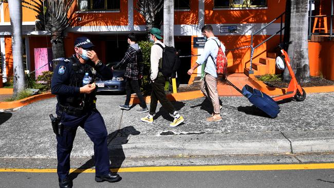 Travellers outside the Brisbane hostel where a guest tested positive. Picture: Dan Peled