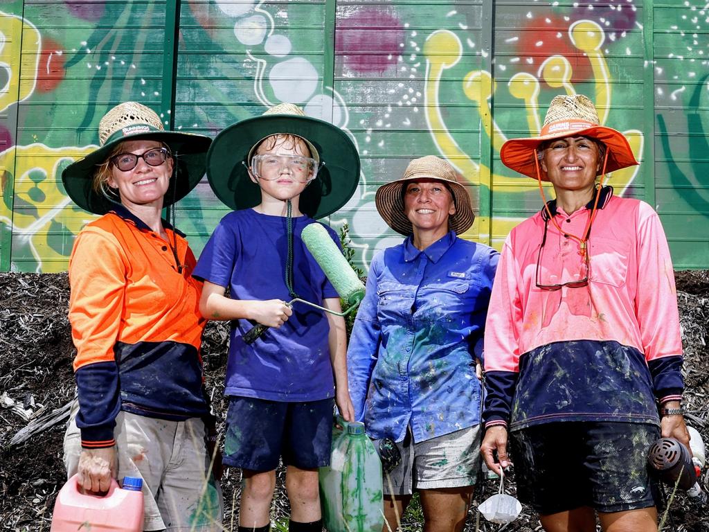 A joint initiative by property developer KenFrost Homes, the Department of Transport and Main Roads and the Cairns Regional Council will see a 700 metre long sound barrier that runs along the Captain Cook Highway at Kewarra Beach painted with nature inspired designs. Artists Amber Hill, Arthur James, 9, Fiona Bell and coordinator Violet Shaban, with the help of other artists, have been painting the fence that runs along the Deep Creek Estate with natural designs, while removing unsightly graffiti tagged onto the wall. Picture: Brendan Radke