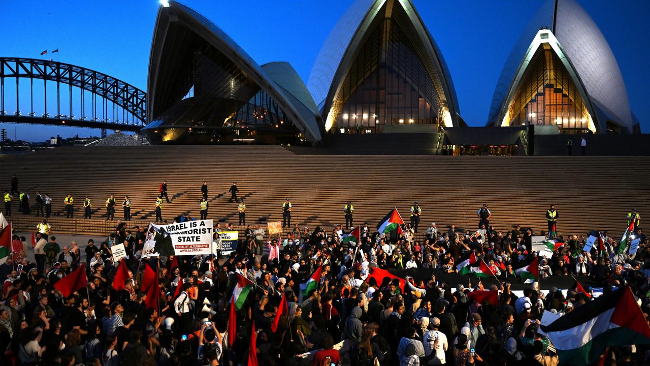 Participants of a Free Palestine rally react outside Sydney Opera House in Sydney.