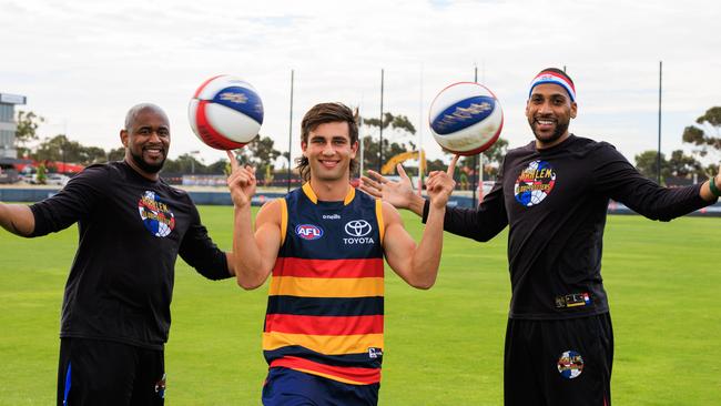 Adelaide’s Josh Rachele was taught some basketball skills by Harlem Globetrotters Scooter Christiansen and Zeus McClurkin at West Lakes on Monday. Picture: Supplied