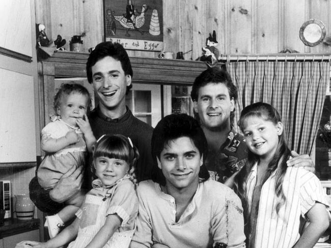 Ashley (or Mary Kate) Olsen with Bob Saget, David Cooulier, Candace Cameron, John Stamos and Jodie Sweetin from Full House.