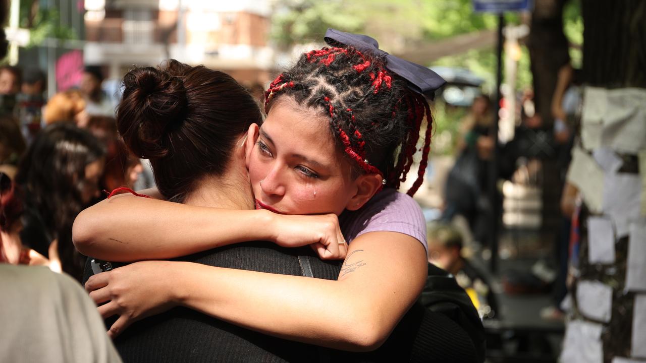 Upset fans embrace as they grieve the loss of the singer. Picture: Tobias Skarlovnik/Getty Images