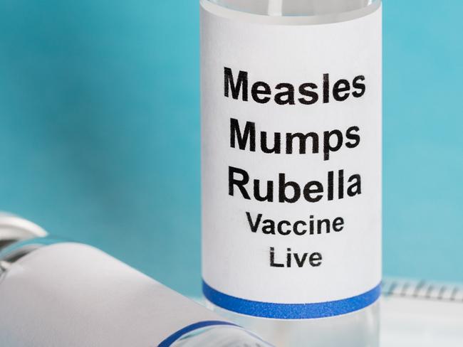 Measles Mumps Rubella Vaccine Vials With Syringe Over Turquoise Background