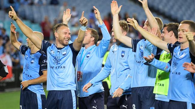 Sydney FC players celebrate winning the Sydney Derby.