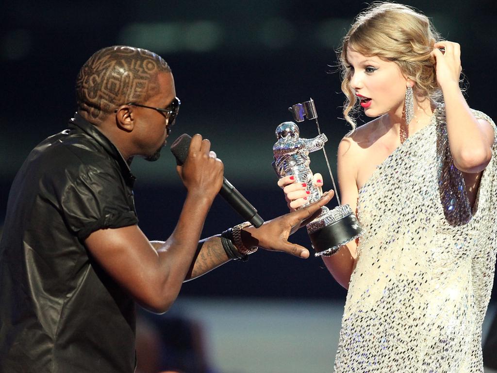 Kanye West (L) jumps onstage after Taylor Swift (C) won the Best Female Video award during the 2009 MTV Video Music Awards. Picture: Getty