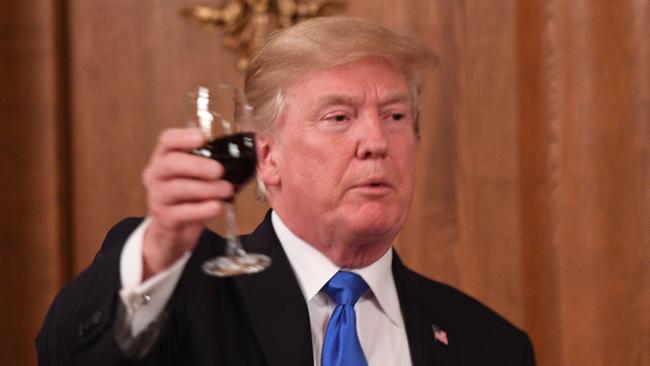 Reputed non-drinker Donald Trump proposes a toast during a state banquet dinner. Picture: AFP