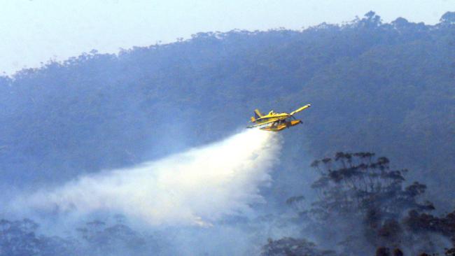 Water bombers targeting the fire at Lower Beechmont. Picture: AAP Image/Richard Gosling