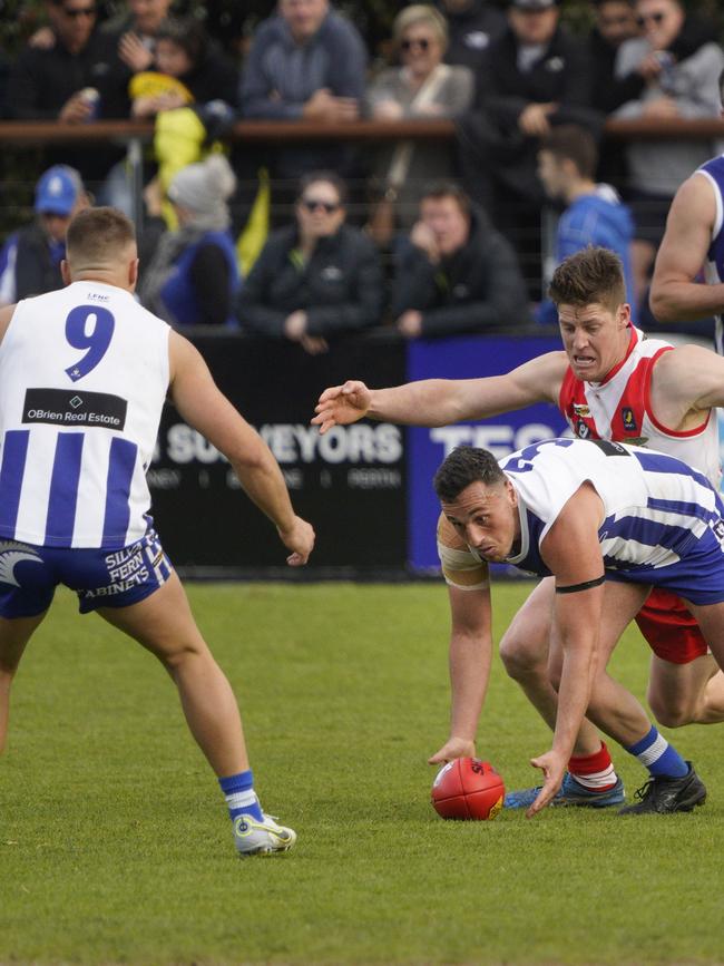 Blake Peach with the ball for Langwarrin and Josh Bateman (No.9).