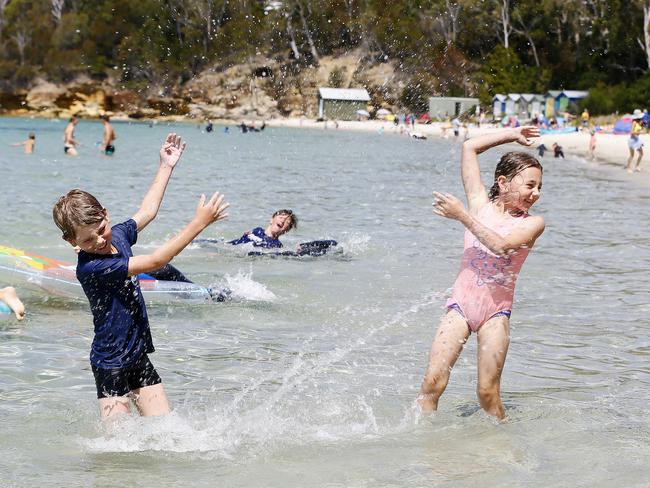 Oakley and Eleanor Thorpe, of Kingston, cool off at Conningham Beach. Picture: MATT THOMPSON