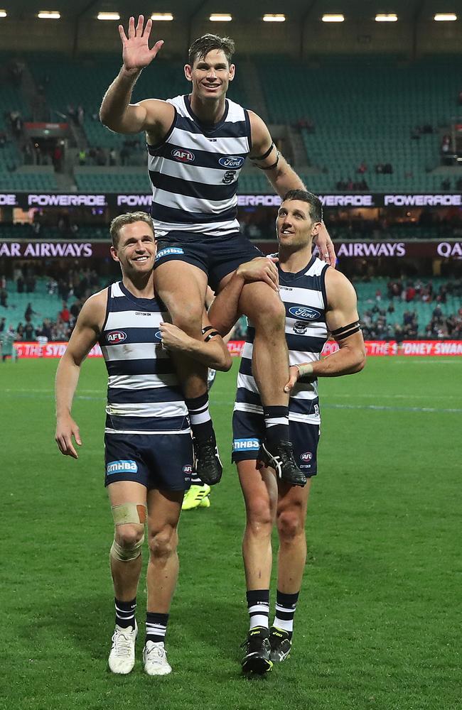 Geelong’s Tom Hawkins is chaired off the SCG in his 250th game by Joel Selwood and Harry Taylor after the win over Sydney Swans. Picture: Phil Hillyard