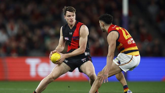 MELBOURNE, AUSTRALIA - JULY 09: Jordan Ridley of the Bombers runs with the ball under pressure from Izak Rankine of the Crows during the round 17 AFL match between Essendon Bombers and Adelaide Crows at Marvel Stadium, on July 09, 2023, in Melbourne, Australia. (Photo by Daniel Pockett/Getty Images)