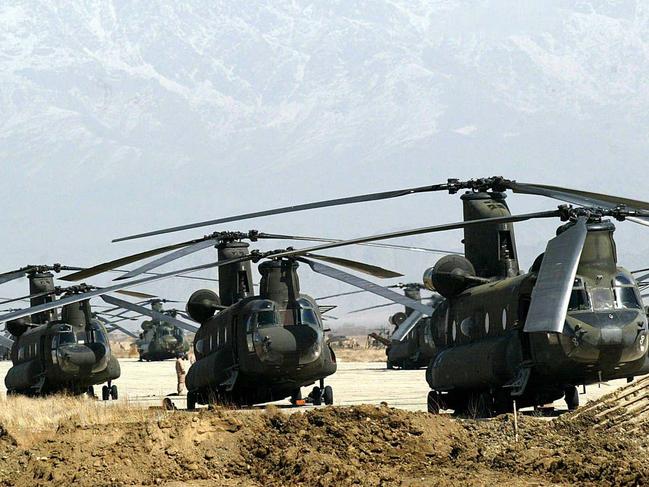 In this file photo taken on March 10, 2002, a squadron of US helicopters are ready to take off, from a military air base in Bagram. - All US and NATO troops have left Bagram Air Base, a US defence official told AFP Friday, signalling the complete withdrawal of foreign forces from Afghanistan was imminent. (Photo by ROSLAN RAHMAN / AFP)