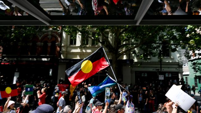 Protesters march from Parliament House to Flinder's Street Station during the Treaty Before Voice Invasion Day Protest.