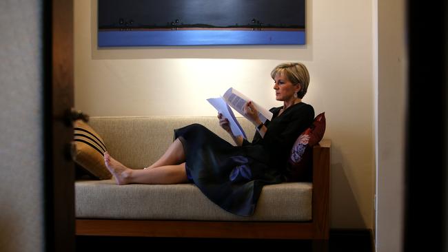 A behind the scenes look at Julie Bishop in her hotel room reading briefing papers while on a visit to Myanmar. Picture: Kym Smith