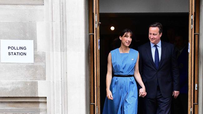 TOPSHOT - British Prime Minister David Cameron and his wife Samantha leave after casting their votes in the EU referendum, at a polling station in London on June 23, 2016. Millions of Britons began voting Thursday in a bitterly-fought, knife-edge referendum that could tear up the island nation's EU membership and spark the greatest emergency of the bloc's 60-year history. / AFP PHOTO / LEON NEAL