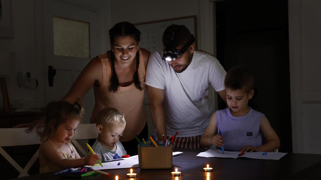 Sarah and Nick Pratt, with their kids, Mimi, Eden and Leo, colour-in by candlelight. Picture: Richard Dobson