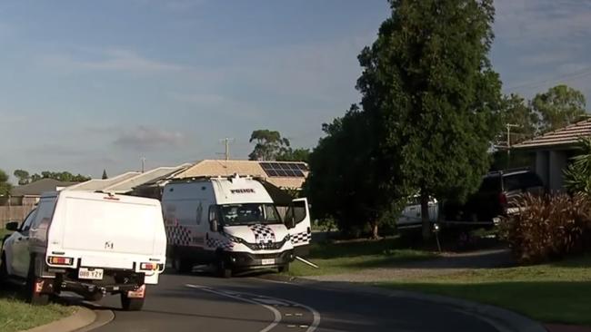 Police at the scene of the Bundamba home after a 19-year-old woman died in hospital on Sunday night. Photo: 7 News