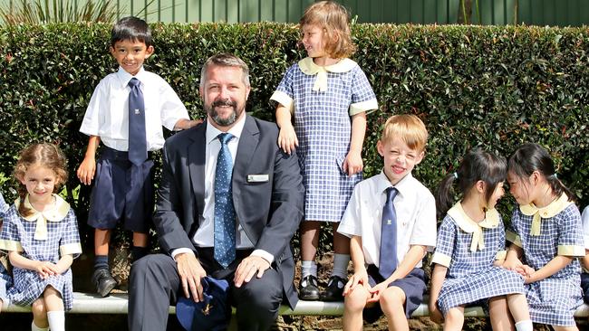 The top ranking primary school on the northern beaches is the John Colet School. Headmaster Julian Wilcock pictured with pupils. Picture: Troy Snook