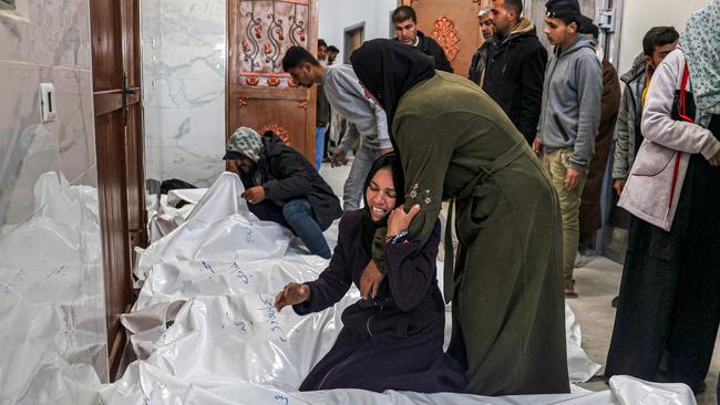 Relatives of Palestinians killed during overnight Israeli bombardment, mourn over their bodies at the hospital morgue in Khan Yunis, Gaza. Picture: AFP
