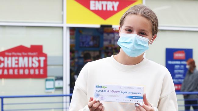 Rosie Pelham, 13, of Hobart with tests her family purchased. People lined up from early morning at Chemist Warehouse in Salamanca to try and purchase a RAT test. They were sold out by around 9.45am with no further stock till at least Monday. Picture: Nikki Davis-Jones