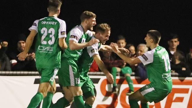 Bentleigh Greens’ Jacob Alexander is congratulated by his teammates after scoring against Heidelberg United at the Kingston Heath Soccer Complex