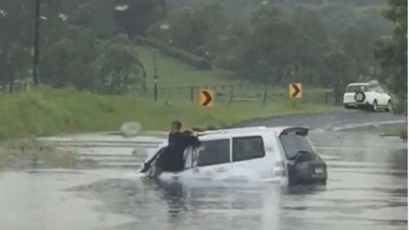 FLOOD RESCUE: A driver and her niece were rescued after their car drove along a flooded road at Boatharbour near Lismore. Emergency services continue to implore drivers to avoid driving through water. Photo: Contributed