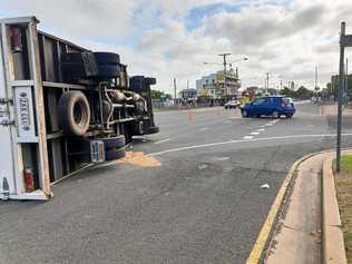 SMASH: A truck has landed on it's side after a crash on the corner of Bourbong St and Burrum St this morning. Picture: Toni Benson-Rogan