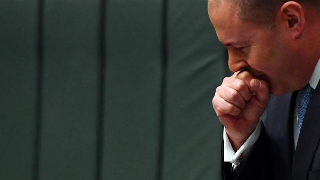 Treasurer Josh Frydenberg coughs in Parliament House, Canberra, on Tuesday. Picture: Getty Images