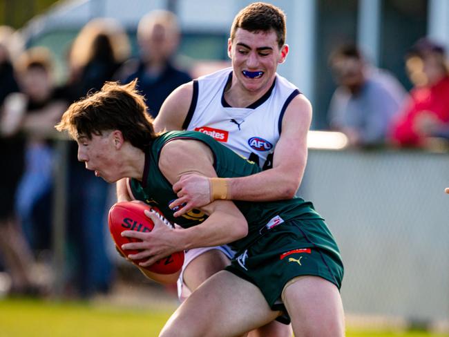 Jack Dolliver of Tasmania Devils is tackled by Geelong Falcons Ethan Borys Picture: Linda Higginson