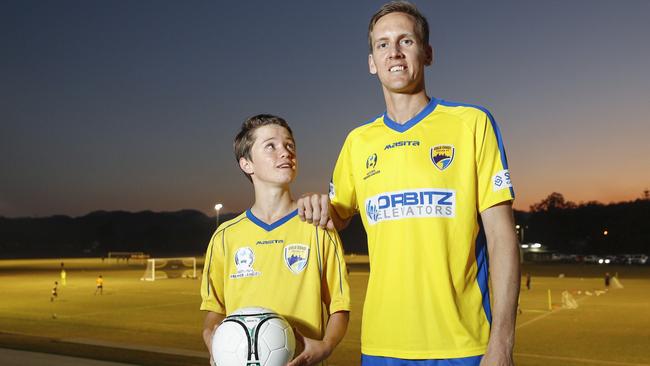 Gold Coast United's Rufus Scott, 13 with former Socceroo Michael Thwaite. Pic Tim Marsden