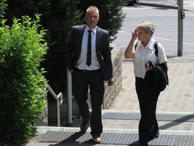 O'Brien arriving at Gosford court with a female supporter and his trademark thongs. Picture: NewsLocal