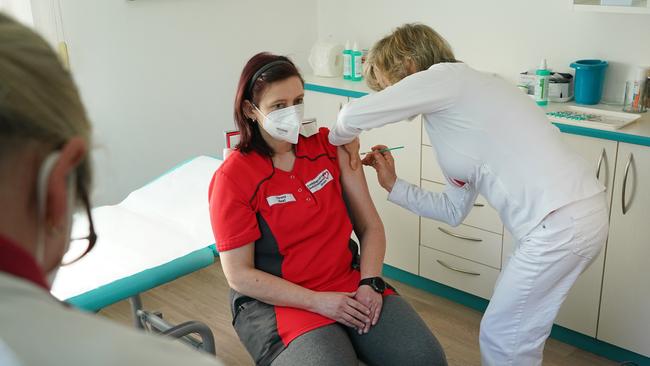 Doctor Claudia Richartz (right) inoculates a health care worker against COVID-19 with the AstraZeneca vaccine in Senftenberg, Germany overnight. Picture: Getty Images