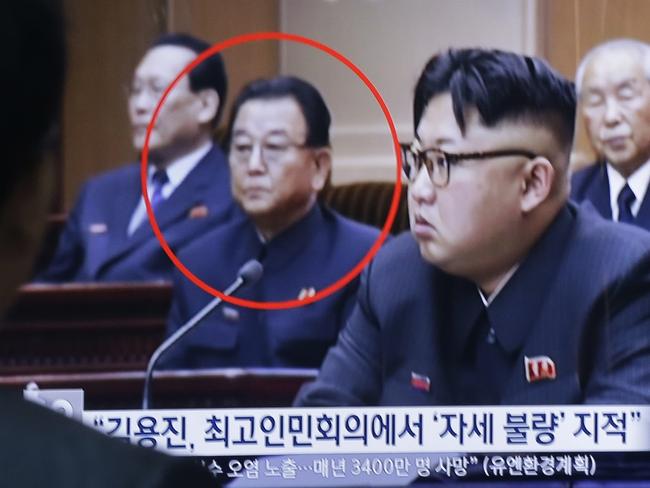 A man watches a TV screen showing a file image of Kim Yong Jin, second from left, a vice premier on education affairs in North Korea's cabinet, and North Korean leader Kim Jong Un, second from right, at the Seoul Railway Station in Seoul, South Korea, Wednesday, Aug. 31, 2016. North Korea has executed a vice premier and banished two other top officials to rural areas for re-education, South Korean officials said Wednesday. The letters read 