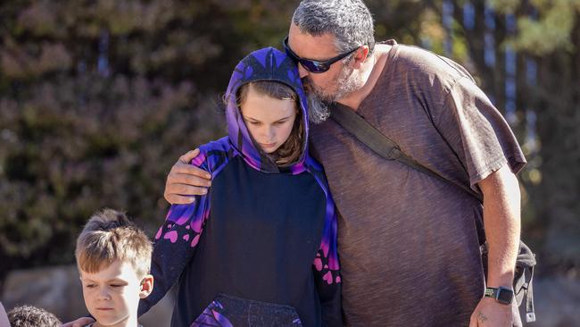 Peter Dodt’s father and sister support each other at the memorial site. Picture: Jason Edwards