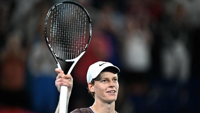 TOPSHOT - Italy's Jannik Sinner celebrates victory against Russia's Andrey Rublev during their men's singles quarter-final match on day 10 of the Australian Open tennis tournament in Melbourne on January 24, 2024. (Photo by Anthony WALLACE / AFP) / -- IMAGE RESTRICTED TO EDITORIAL USE - STRICTLY NO COMMERCIAL USE --