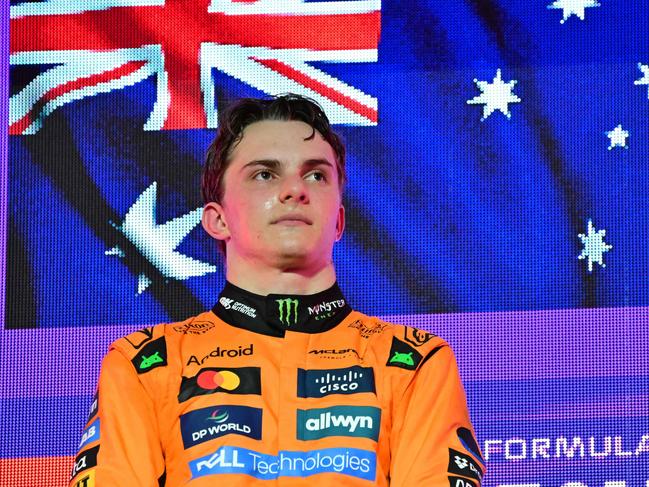 McLaren's Australian driver Oscar Piastri stands on the podium during the trophy ceremony after winning the 2025 Saudi Arabia Formula One Grand Prix at the Jeddah Corniche Circuit on April 20, 2025. (Photo by Giuseppe CACACE / AFP)