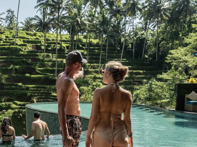 UBUD, BALI, INDONESIA - DECEMBER 8: Foreign tourists use a swimming pool with a rice terrace in the background on December 8, 2022 in Ubud, Bali, Indonesia. Indonesia's parliament voted to pass a law that bans extramarital sex on Tuesday, in a move that critics quoted in local media have said will severely impact the tourism industry. Regions like Bali rely heavily on an influx of foreign tourists to keep their economies afloat, and the new law has raised concerns just as international arrivals start to pick up again post-pandemic.  (Photo by Agung Parameswara/Getty Images)